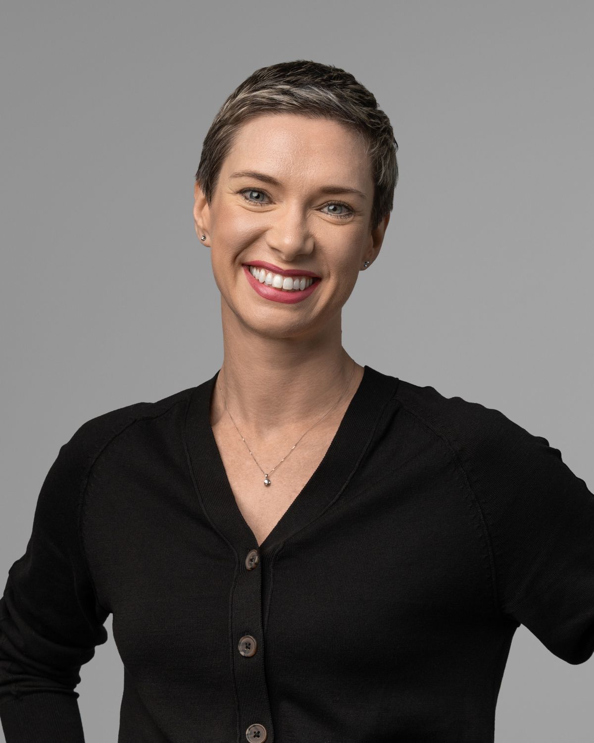 Confident corporate headshot of a professional woman in a dark top